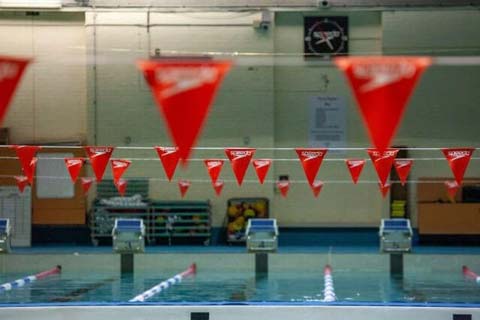 Image of the UNSW Fitness and Aquatic Centre pool with red bunting.